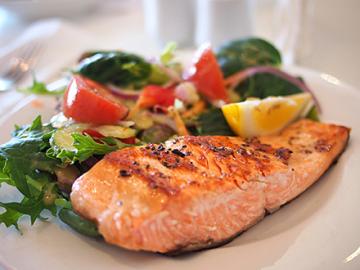A plate of grilled salmon and vegetables