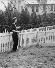 historical photo of two people talking over a fence