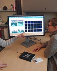 ARS scientists review microscope images and data on a computer screen