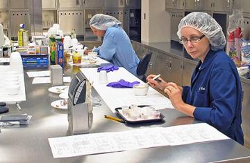 ARS food technologists perform a sensory panel taste test of catfish samples.