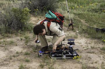 Grad student, Sonia Roberts performs field testing with the (RHEX) robot hexapod