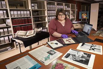 Jamie Flood updating Wikipedia entries about the special collections of Dr. Hazel Stiebling and watercolorist, Deborah Passmore .