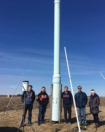 University of Chicago agricultural engineering students standing near a suction trap.