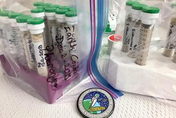 Plastic bags labeled 'Earth Control December 2019 Pheronym' filled with glass tubes containing sand and nematodes.