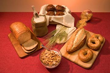 Bran muffins, brown rice, a loaf of whole-wheat bread, whole-wheat bagels, and whole-grain cereal.