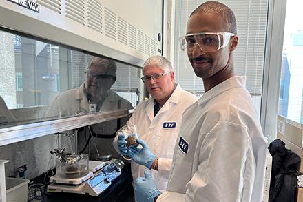 Two male scientists working in a lab.