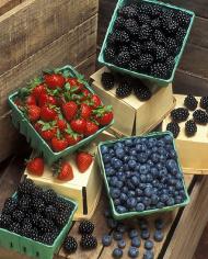 Containers of blackberries, blueberries, and strawberries.